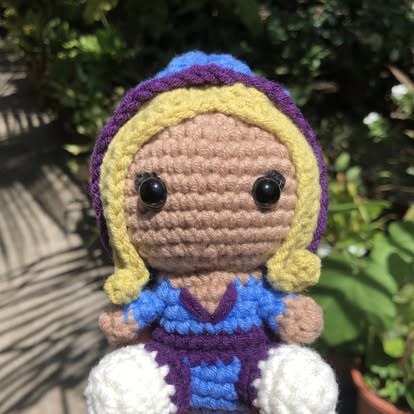 A crochet amigurumi in progress, on the studio table